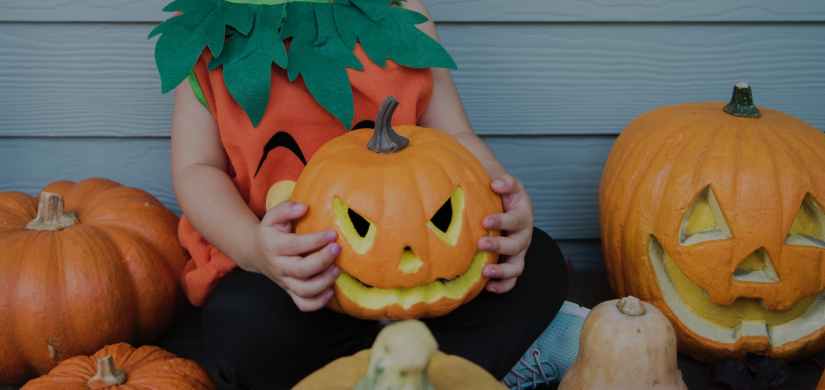 photo of child holding jack o lantern